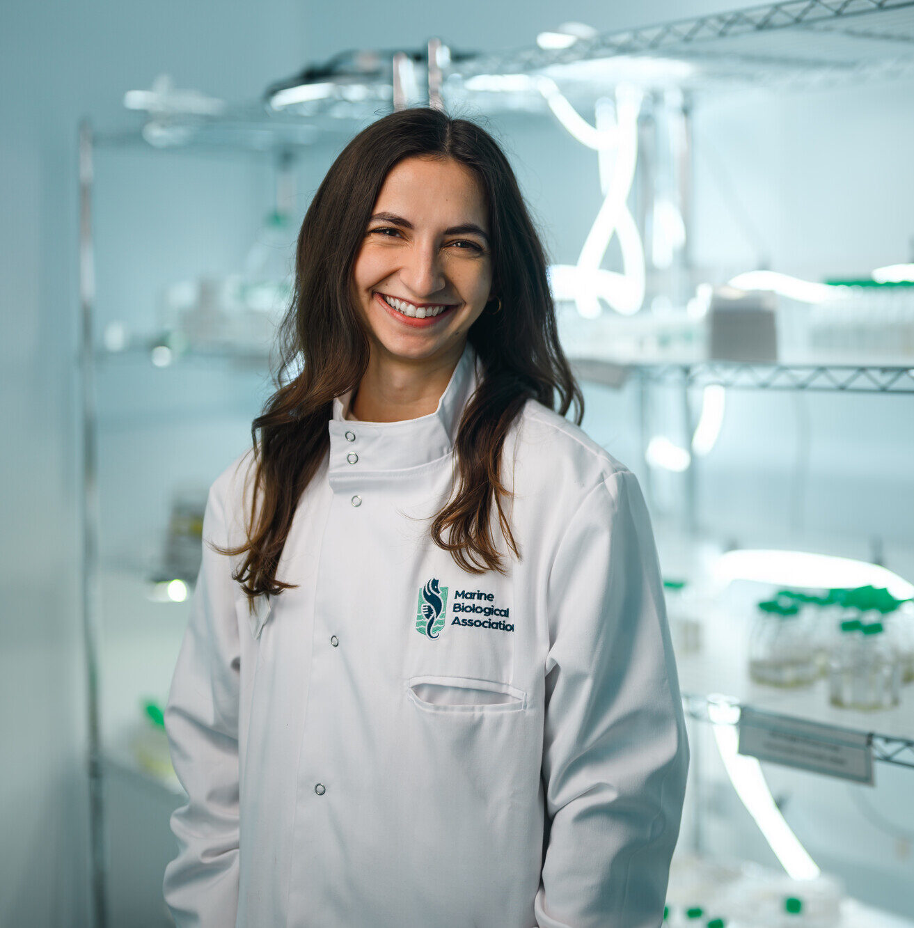 Courtney standing in front of algae collection