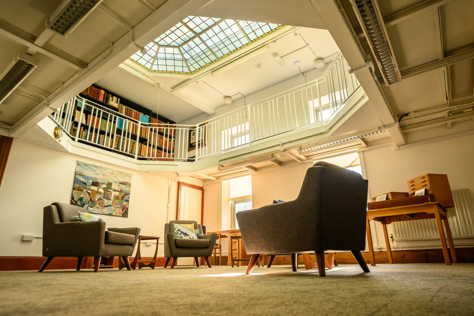 MBA Library with comfy seats surrounded by books and sunlight 